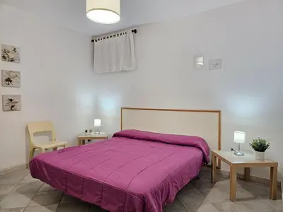a bedroom with a bed with a purple blanket at Holiday Home Ferienvilla mit Wasserblick by Interhome in Campofelice di Roccella