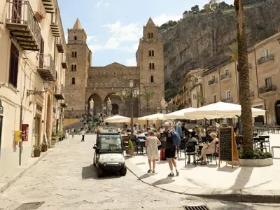 a group of people walking down a street in a city at Holiday Home Ferienvilla mit Wasserblick by Interhome in Campofelice di Roccella