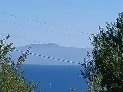 a view of a body of water from between two trees at Holiday Home Manderino-Panoramasuite mit Park und Pool by Interhome in Santa Flavia