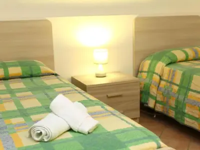 a bedroom with two beds and a lamp on a night stand at Holiday Home Ferienvilla mit Wasserblick by Interhome in Campofelice di Roccella