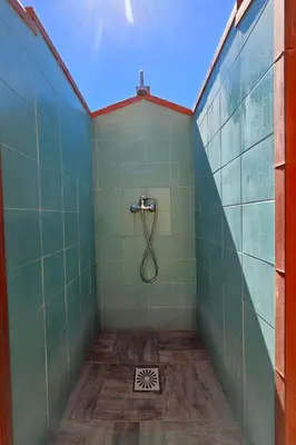 a bathroom with a shower with green tiled walls at Holiday Home Ferienvilla mit Wasserblick by Interhome in Campofelice di Roccella