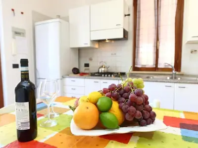a plate of fruit on a table with a bottle of wine at Holiday Home Ferienvilla mit Wasserblick by Interhome in Campofelice di Roccella