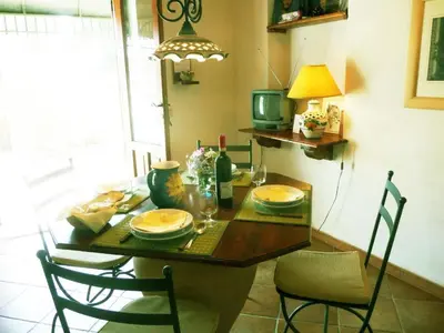 a dining room table with chairs and a table with food on it at Holiday Home 'Suite Ficodindia by Interhome in Santa Flavia