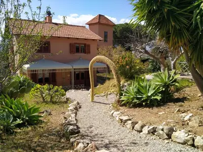a house with a gate in front of a yard at Holiday Home 'Suite Ficodindia by Interhome in Santa Flavia