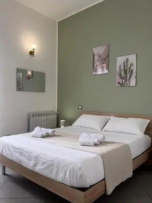a bedroom with a large bed with towels on it at VITALENTA Palermo apartment in Palermo