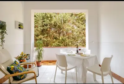 a white table and chairs in a room with a window at Stella a 3 minuti dal mare e a 30 Min from San Vito in Alcamo Marina