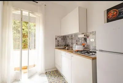 a white kitchen with a stove and a window at Stella a 3 minuti dal mare e a 30 Min from San Vito in Alcamo Marina