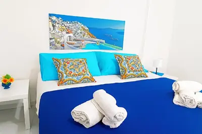 a blue and white bedroom with towels on a bed at Per Famiglie ed Amici a 3 minuti a piedi dal mare Rosso Corallo Alcamo Marina in Alcamo Marina