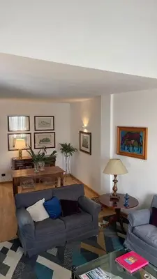 a living room with two couches and a table at Dimora Blu in Palermo