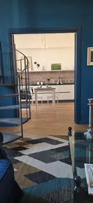 a living room with a staircase and a table at Dimora Blu in Palermo