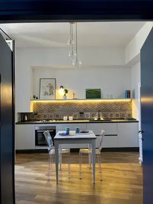 a dining room with a table and chairs in a kitchen at Dimora Blu in Palermo