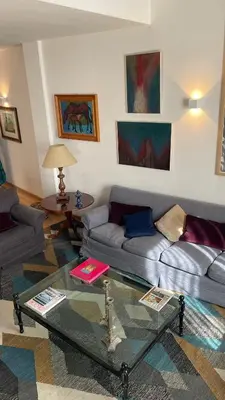 a living room with a couch and a glass table at Dimora Blu in Palermo