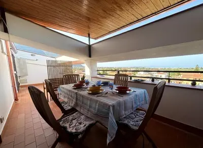 a dining room with a table and chairs with a view at casa 3 nodi in Carini