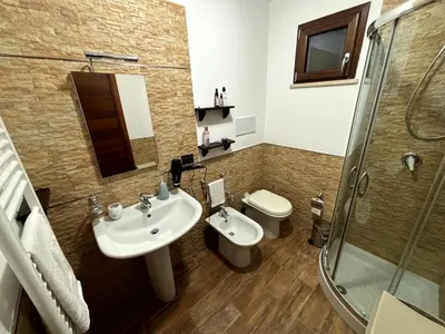 a bathroom with a sink and a toilet and a shower at casa 3 nodi in Carini