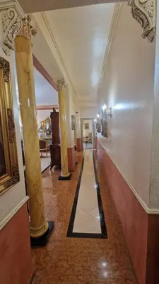 a hallway of a building with columns and a hallwayngth at Casa mogia in Palermo
