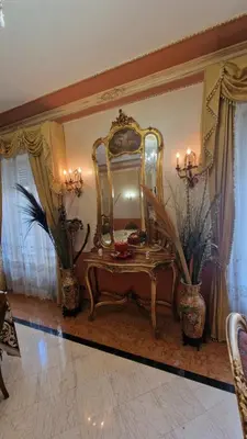a room with a vanity with a large mirror at Casa mogia in Palermo