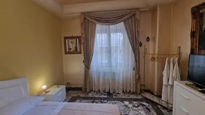 a bedroom with a bed and a large window at Casa mogia in Palermo