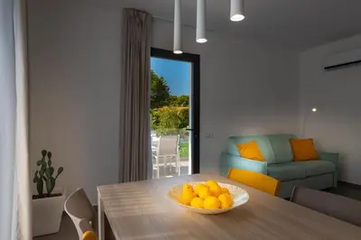 a bowl of oranges on a table in a living room at Gelso Bianco Collection Apartments in Campofelice di Roccella