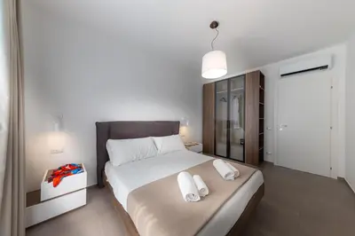 a bedroom with a large bed with two towels on it at Gelso Bianco Collection Apartments in Campofelice di Roccella