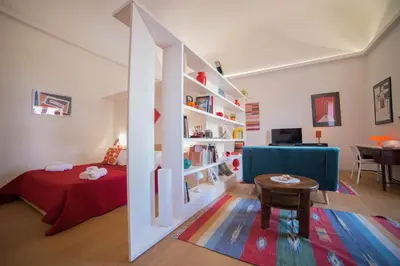 a living room with a book shelf with books at Adenzia apartment in Palermo