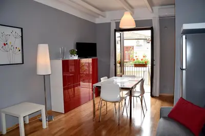 a kitchen and living room with a table and chairs at New Palermo Holidays Penelope in Mondello