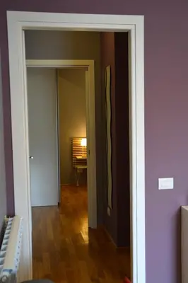 a hallway with a door open to a room with a table at New Palermo Holidays Penelope in Mondello