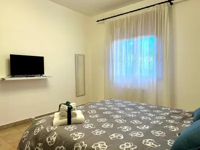 a bedroom with a bed with a dog on it at Casa Verdi in Corleone