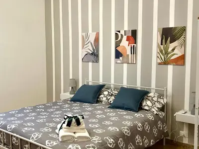 a bedroom with a bed and a tv and a window at Casa Verdi in Corleone
