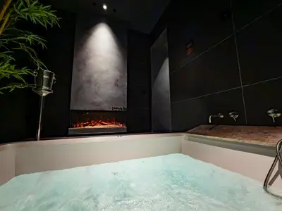 a bath tub with a bottle of wine in it at B Suite Spa in Palermo
