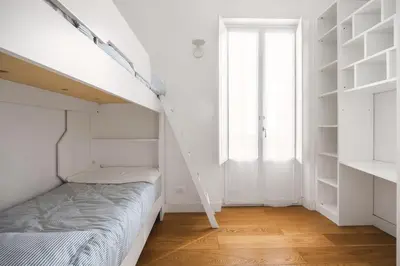a small bedroom with a bed and a window at Giada's House By DomuSicily in Palermo