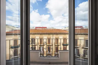 an open window with a view of a building at Giada's House By DomuSicily in Palermo