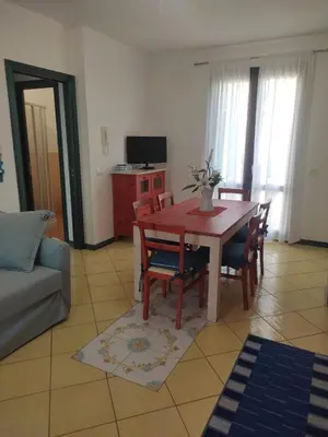 a living room with a table and chairs and a couch at Casa di Lolli in San Vito lo Capo