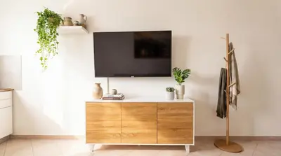 a living room with a tv on a white wall at Apollo Apartment in Palermo