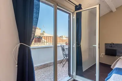 a sliding glass door with a view of a balcony at Casa Peppa by Wonderful Italy in Palermo