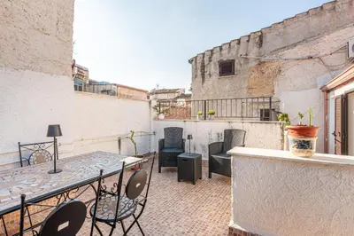 a balcony with a table and chairs on a building at Casa Peppa by Wonderful Italy in Palermo