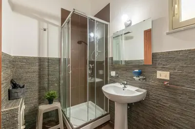 a bathroom with a glass shower and a sink at Casa Peppa by Wonderful Italy in Palermo