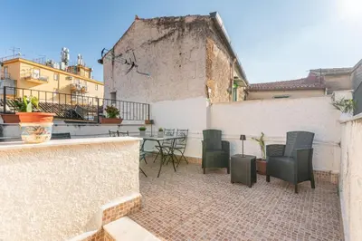 a patio with chairs and a table on a building at Casa Peppa by Wonderful Italy in Palermo