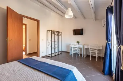 a room with a bed and a table and chairs at Casa Peppa by Wonderful Italy in Palermo