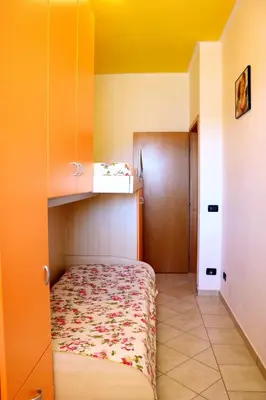 a small bedroom with a bed in a room at Villetta Gelsomini, San Vito Lo Capo in San Vito lo Capo