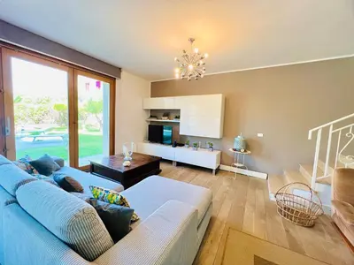 a living room with a blue couch and a table at Villa Donna Vincenza