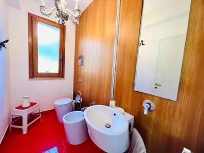 a bathroom with a white sink and a mirror at Villa Donna Vincenza