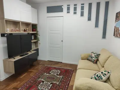 a living room with a couch and a tv at Susy's home in Palermo