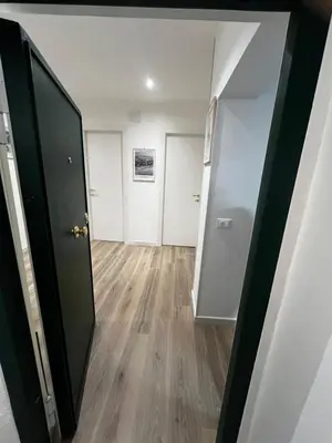 an empty room with a hallway with two doors at A CASA DI LILLY - BALLARò' - in Palermo
