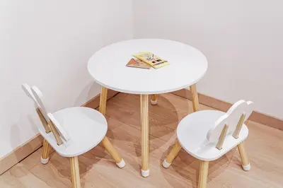 a white table with two chairs and a book on it at Maison Vulpi in Palermo