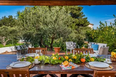 a wooden table with fruits and vegetables on it at Villa Giummara Cala bianca in Castellammare del Golfo
