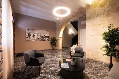 a waiting room with two chairs and a table at Ciuri di Sicilia Apartments in Castellammare del Golfo