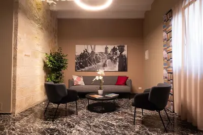 a living room with a couch and chairs and a table at Ciuri di Sicilia Apartments in Castellammare del Golfo