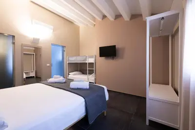 a bedroom with a bed with a painting on the wall at Ciuri di Sicilia Apartments in Castellammare del Golfo