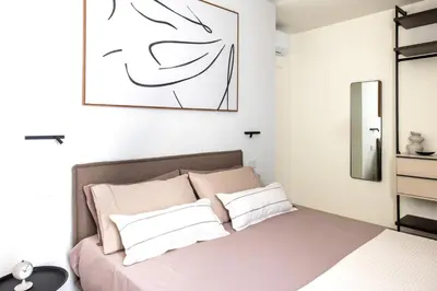 a bedroom with a bed and a picture on the wall at Casa Marella in Balestrate