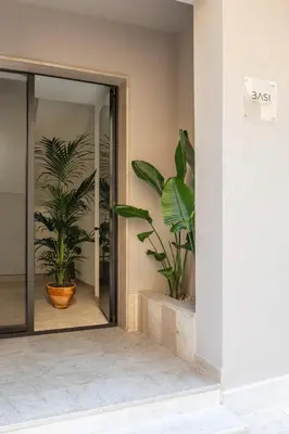 an entrance to a building with two potted plants at Casa Marella in Balestrate